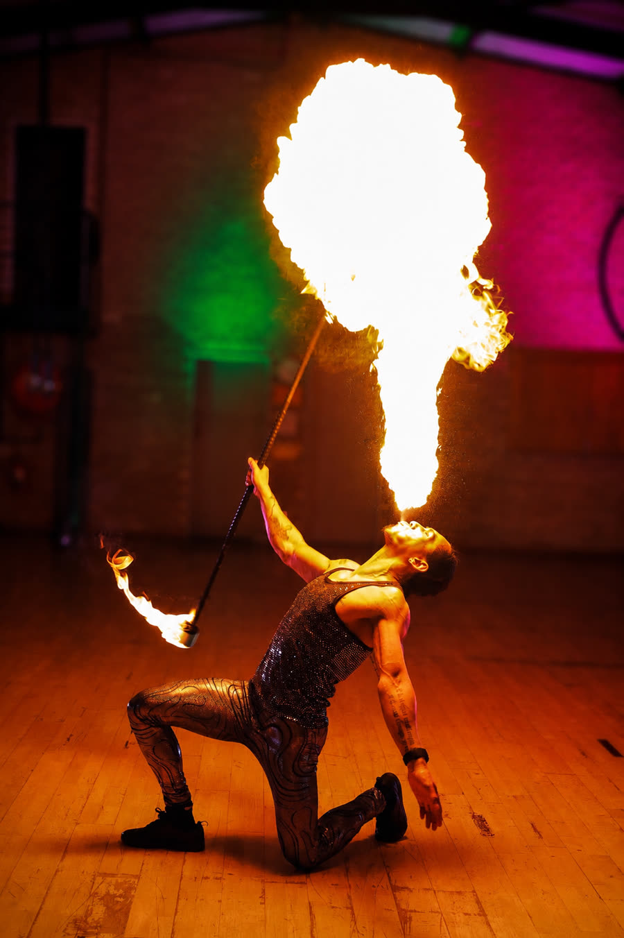 Fire fan and poi performer spinning flames at a private party